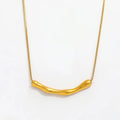 A M A R A sculptural gold plated necklace on white background 
