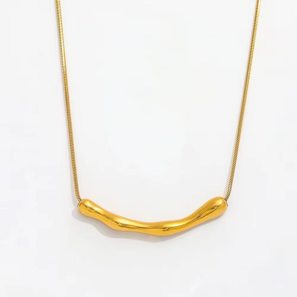 A M A R A sculptural gold plated necklace on white background 