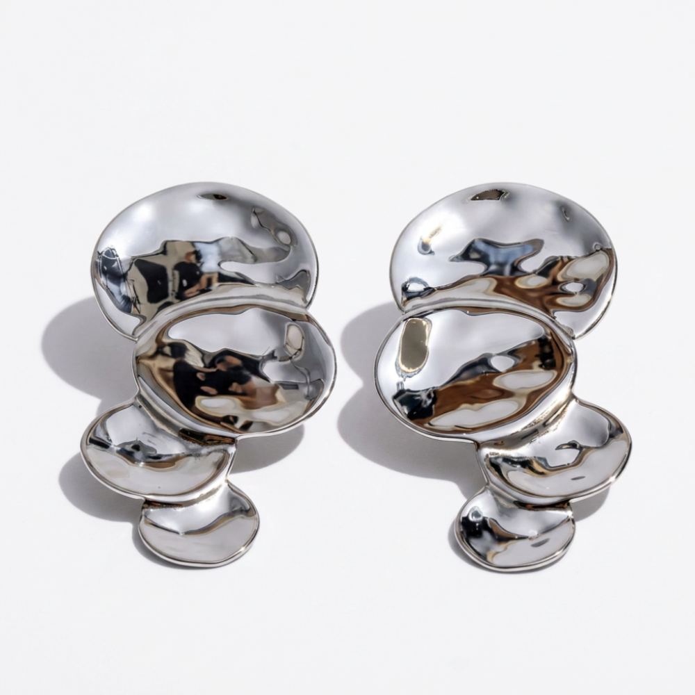 AURELIA stainless steel sculptural statement earrings on white background