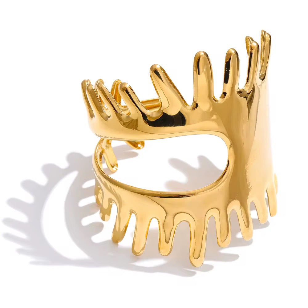 Gold crown-shaped bracelet on a white background