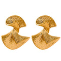 Pair of gold sculptural earrings on a white background