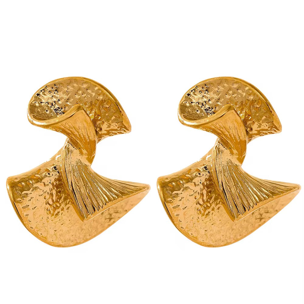 Pair of gold sculptural earrings on a white background