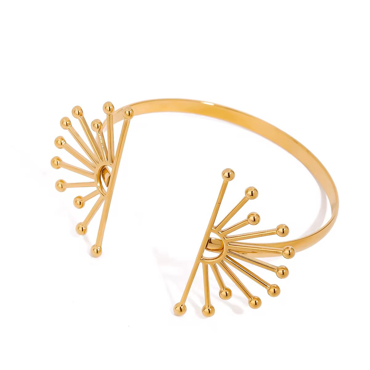 Gold bracelet with  sunburst design on a white background